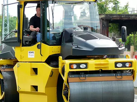 Person driving yellow tractor