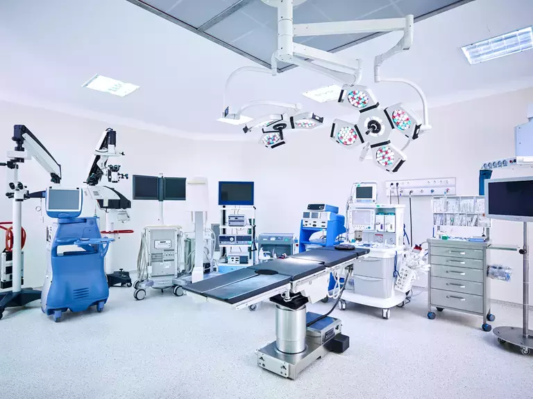 Image showing robotic surgery in an operating theatre, no people.
