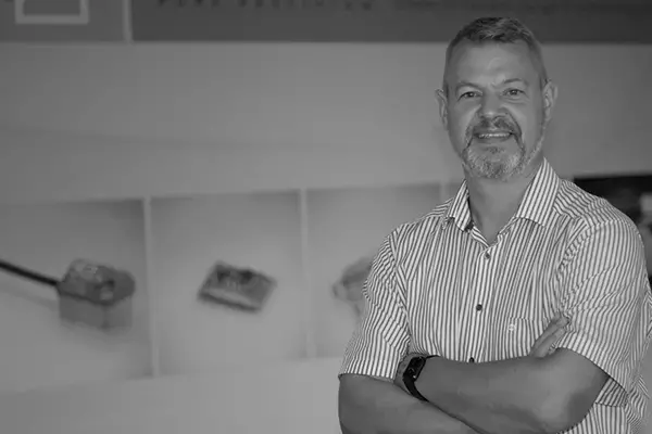 Headshot of Norbert Gehri in front of mg-sensor banner