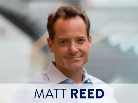 Headshot of Matt Reed with blurred office background