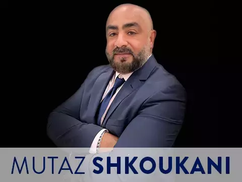 Headshot of Mutaz Shkoukani with black background