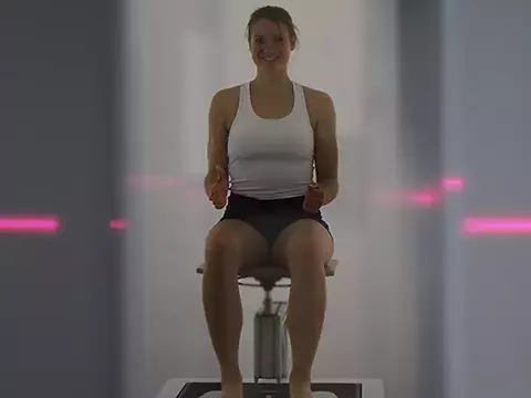 Woman sitting in a body scanner