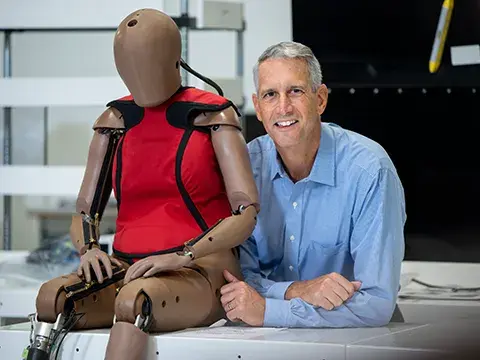 Headshot of Humanetics CEO, Chris O'Connor, with THOR-5F