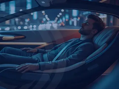 Man reclined in an automous vehicle