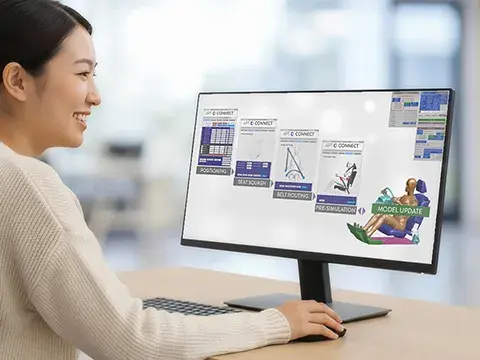 A photo of a woman working on virtual crash safety software at her desk
