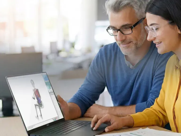 A photo of a man and woman working with an HBM model on a laptop