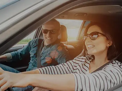 Woman driving with male in passenger seat