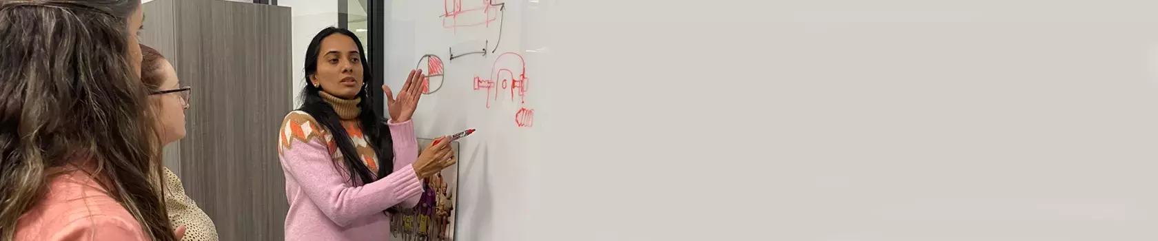 Group of women engineers at a whiteboard